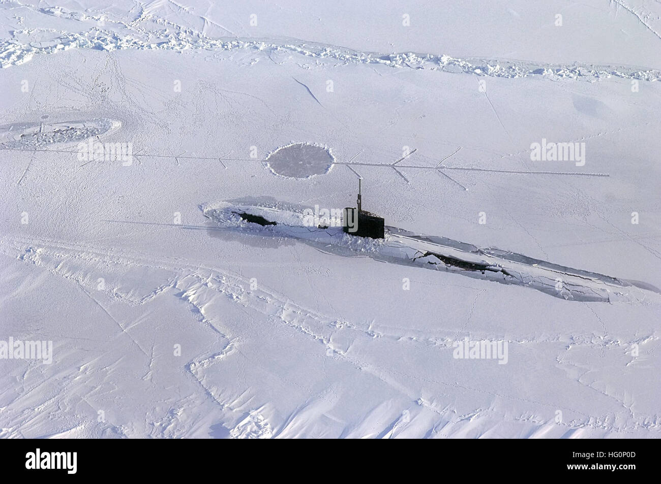 US Navy 070318-N-3642E-473 Los Angeles-class fast attack submarine USS Alexandria (SSN 757) is submerged after surfacing through two feet of ice during ICEX-07, a U.S. Navy and Royal Navy exercise Stock Photo