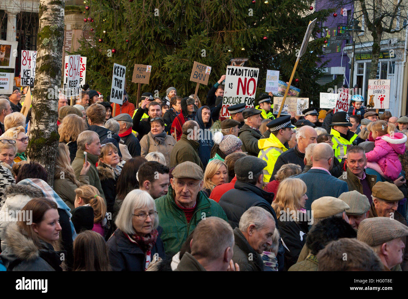 Carmarthen, Carmarthenshire, Wales, UK. 2nd January, 2016. Police keep hunt supporters and hunt protesters apart. Anti-Bloodsport activists gather in the Welsh town of Carmarthen to voice their anger at the continued illegal hunting with dogs - hunting with dogs was made illegal in 2004 by The Hunting Act 2004 (c37). The Anti-Hunt protest takes place on the day that the Carmarthenshire Hunt have chosen to parade through the town to collect money and support for their blood-sports. © Graham M. Lawrence/Alamy Live News. Stock Photo