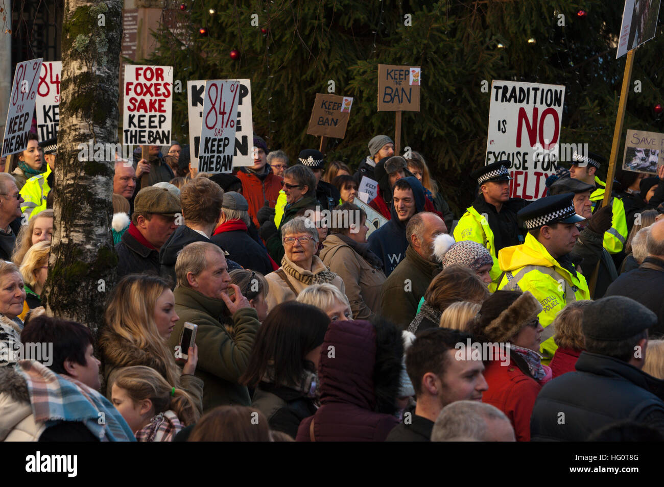 Carmarthen, Carmarthenshire, Wales, UK. 2nd January, 2016. Police keep hunt supporters and hunt protesters apart. Anti-Bloodsport activists gather in the Welsh town of Carmarthen to voice their anger at the continued illegal hunting with dogs - hunting with dogs was made illegal in 2004 by The Hunting Act 2004 (c37). The Anti-Hunt protest takes place on the day that the Carmarthenshire Hunt have chosen to parade through the town to collect money and support for their blood-sports. © Graham M. Lawrence/Alamy Live News. Stock Photo