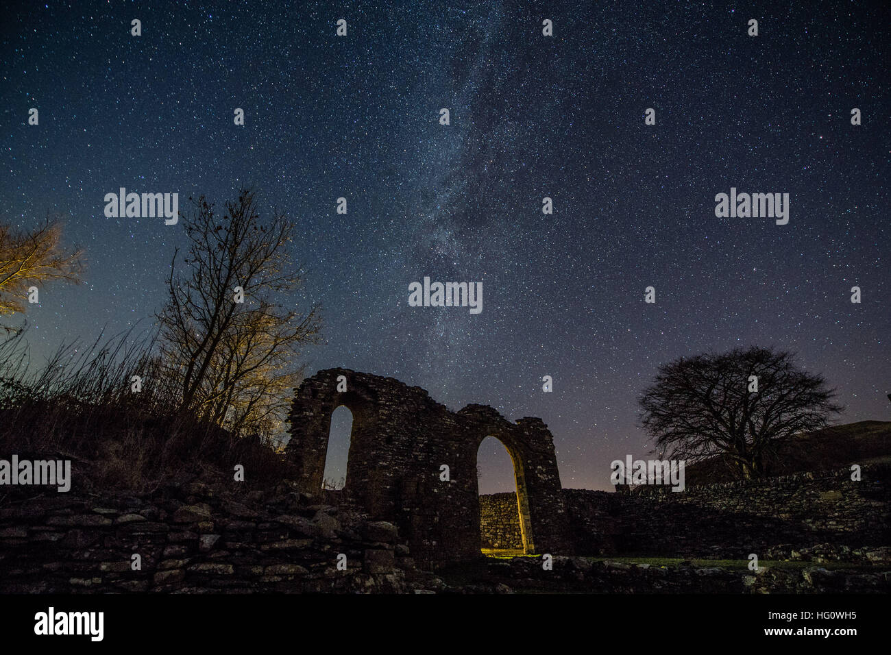 The Milky Way over Wales UK: On a cold clear and frosty night, with temperatures dropping to minus 5º celsius, the Milky Way is clearly seen as a thick band of stars across the skies above the arch shaped ruins of the medieval Strata Florida (Ystrad Fflur) Cistercian abbey in Pontrhydfendigaid, Ceredigion, mid Wales photo © keith morris/Alamy Live News Stock Photo