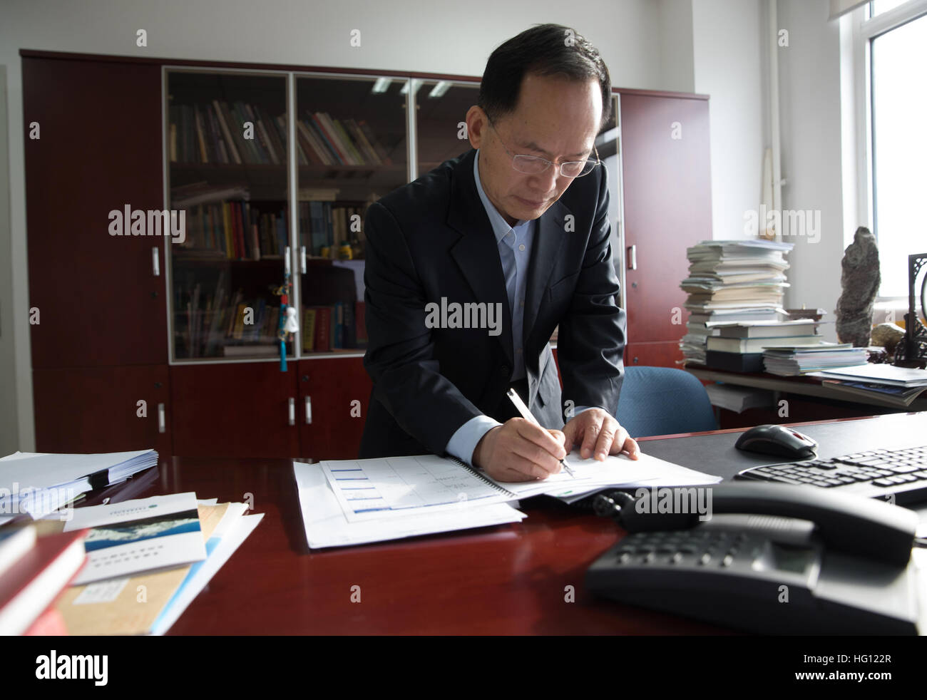 Beijing, China. 26th Dec, 2016. Yao Tandong, an academician with the Qinghai-Tibet Plateau Institute under the Chinese Academy of Sciences (CAS), works at his office in Beijing, China, Dec. 26, 2016. The Swedish Society for Anthropology and Geography (SSAG) has decided to award the 2017 Vega Medal to Professor Yao Tandong for his contributions to research on glaciers and the environment on the Tibetan Plateau. Yao is the first Asian scientist to win the award. © Jin Liwang/Xinhua/Alamy Live News Stock Photo