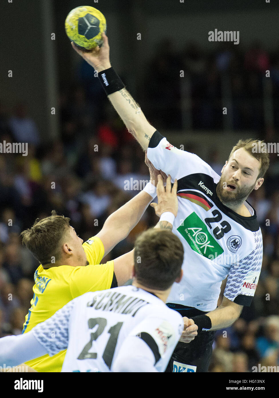 Krefeld, Germany. 03rd Jan, 2017. Romania's Giorgian Cristescu (l) in action against Germany's Steffen Faeth in the national league handball game between Germany and Romania the Koenigpalast in Krefeld, Germany, 03 January 2017. Photo: Marius Becker/dpa/Alamy Live News Stock Photo