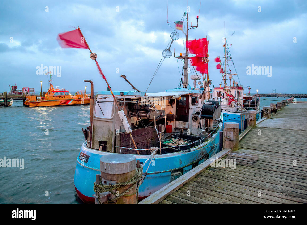 Red marker flags for gilnets flap in the wind on the Baltic Sea island of Poel at the port of Timmendorf, Germany, 4 January 2017. Storm Axel is expected to cause storm tides along the German Baltic Sea coast in the evening of 4 January 2017. Photo: Jens Büttner/dpa-Zentralbild/dpa Stock Photo