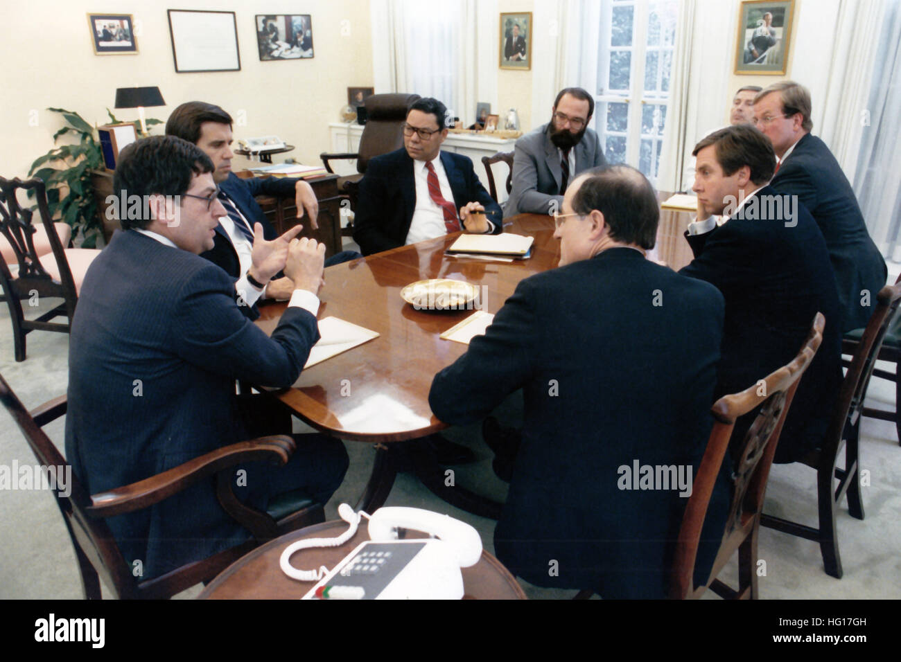 White House Chief of Staff Ken Duberstein (left) joins other members of the Transition Team in their first meeting at the White House in Washington, DC on November 10, 1988. Attending the meeting were: (clockwise from left) Craig Fuller, President-elect George H.W. Bush's current Chief of Staff; Colin Powell, National Security Advisor; Dan Crippen, Assistant to the President; M.B. Oglesby, Deputy Chief of Staff; A.B. Culvahouse, Counsel to the President; John Tuck, Assistant to the President; and Robert Teeter, co-director of the Bush Transition Team with Fuller. The Meeting was held in the of Stock Photo