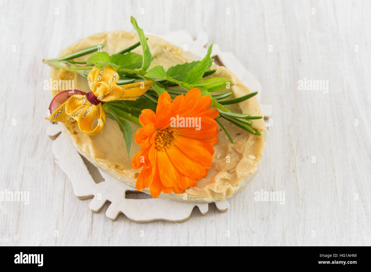 Herbal soap and an orange marigold flower Stock Photo