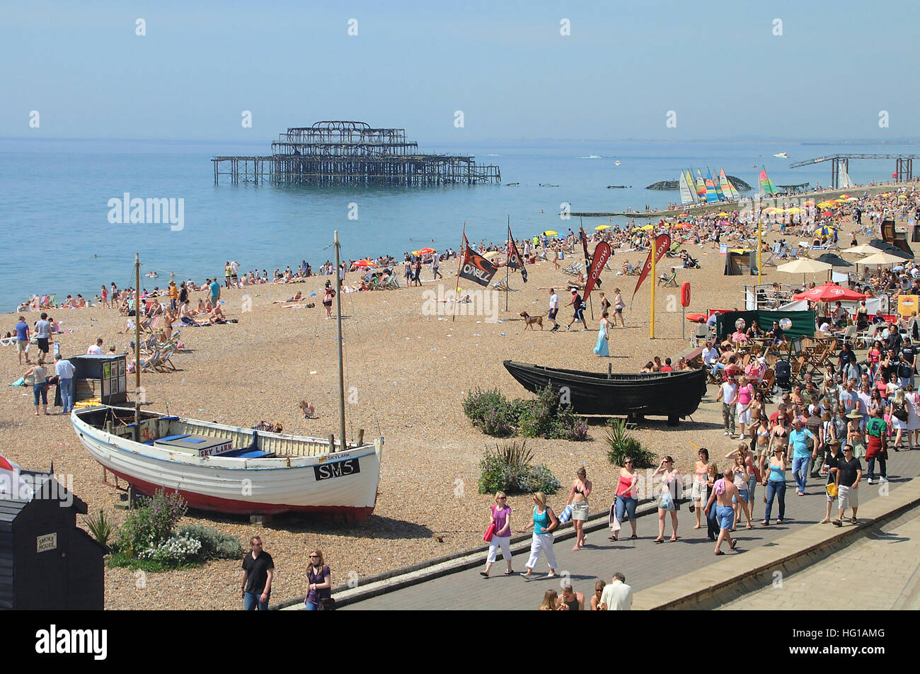 Fishing boats display on Brighton seafront with the remains of old west pier in the background. Sussex, England. Stock Photo