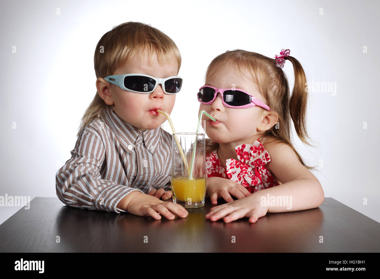 boy and girl drinking juice Stock Photo Alamy