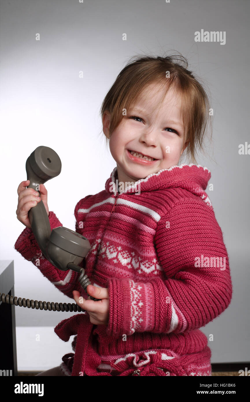 little girl using old phone Stock Photo Alamy