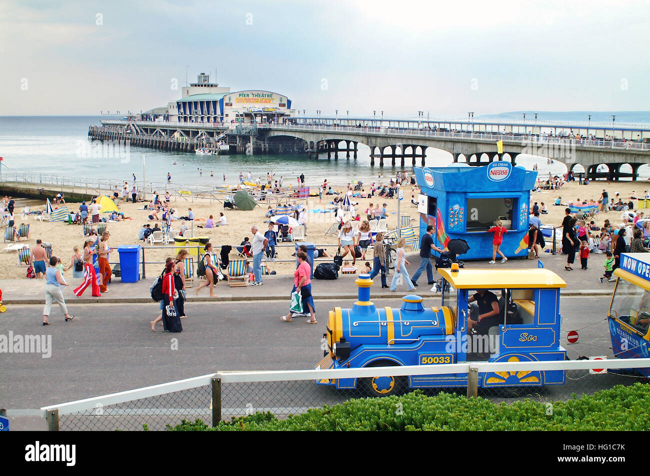 Bournemouth's promenade land train, seafront, and pier in the background. Stock Photo