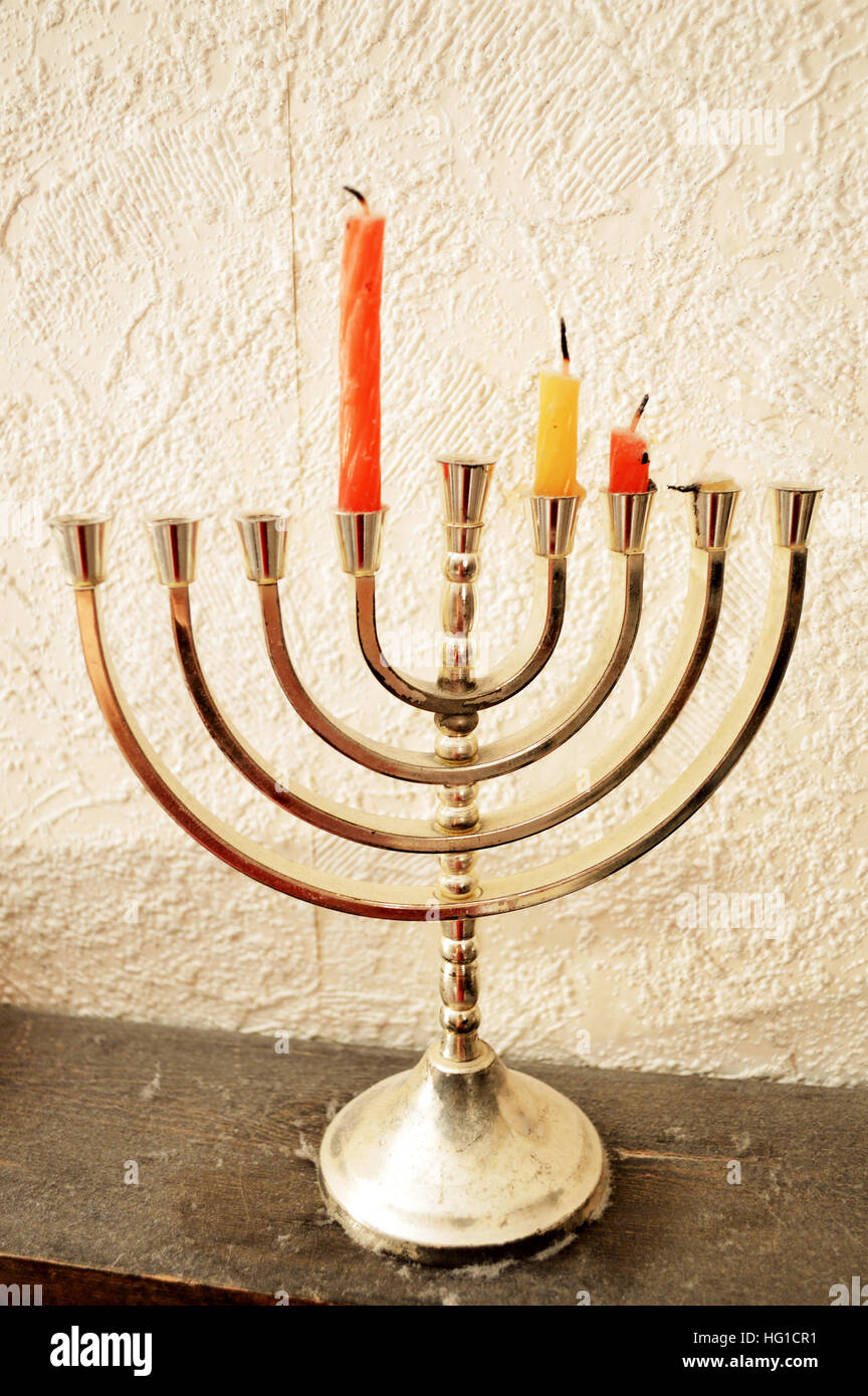 A metal Hanukkah Menorah, or Hanukkiah, with three candles Stock Photo