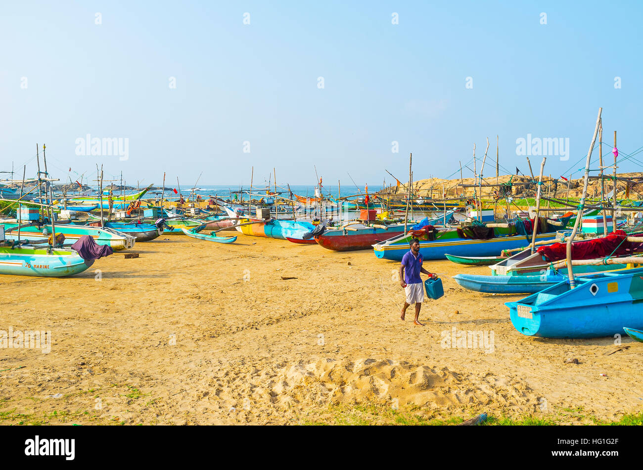 The traditional catamaran-boats, painted in different colors, on the sand at the fishing harbor Stock Photo