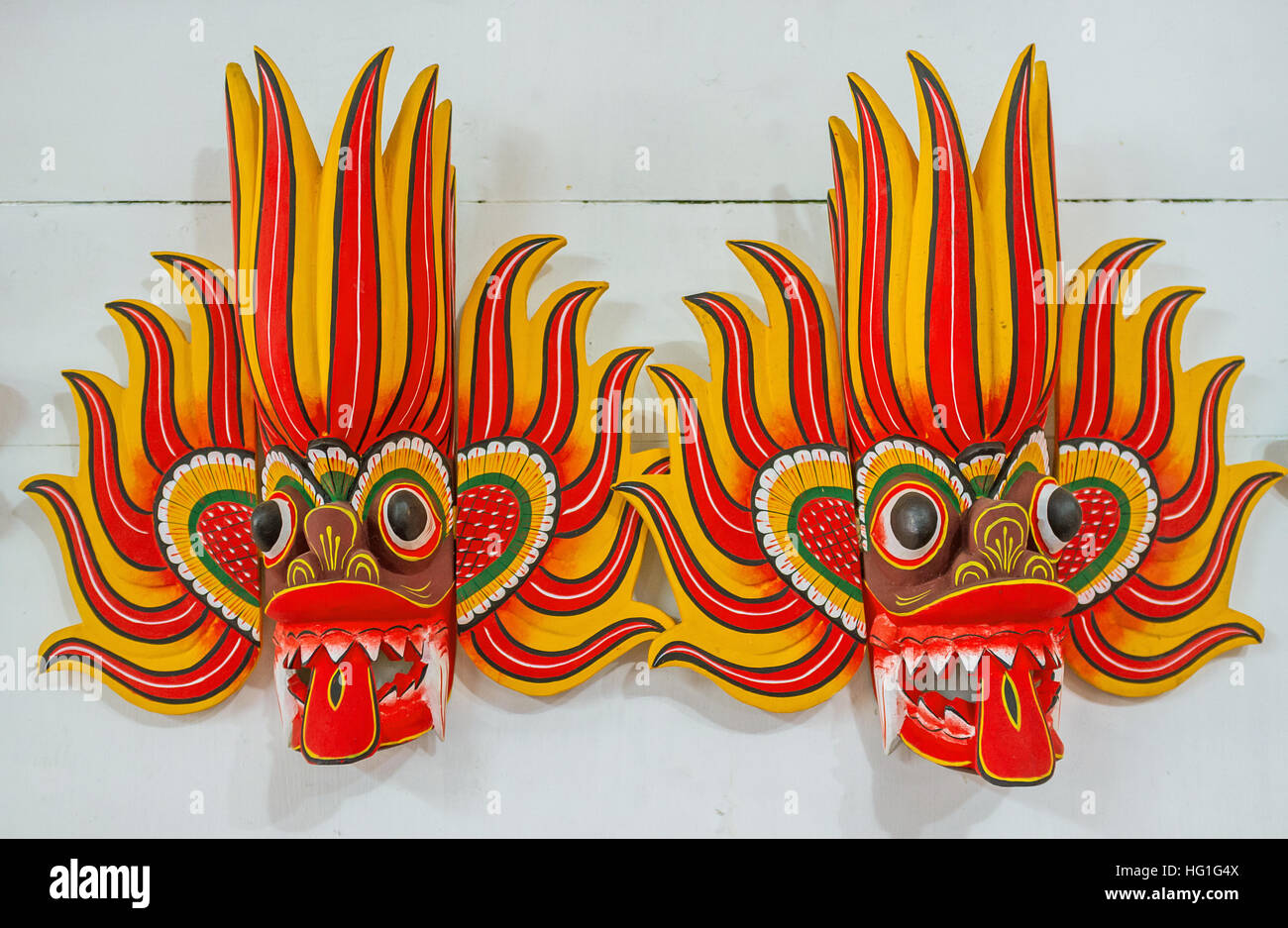 The Ginidella Raksha masks are used by Fire dancers to ward off evil, they decorated in bright red and yellow colors Stock Photo