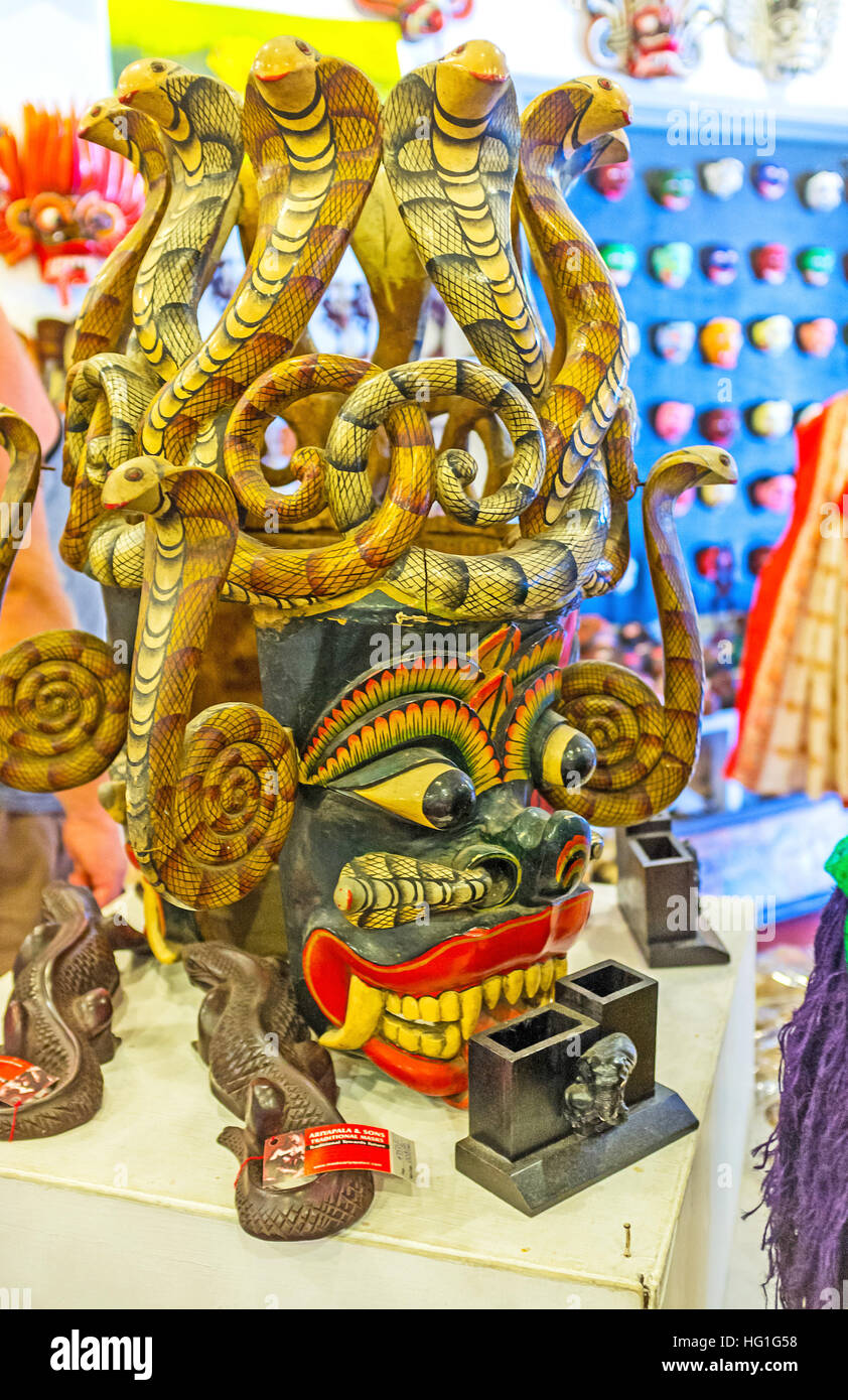 The handmade carved wooden Naga Mask, decorated with numerous cobras, it's used in ritual Devil Dance to fright away the demons Stock Photo