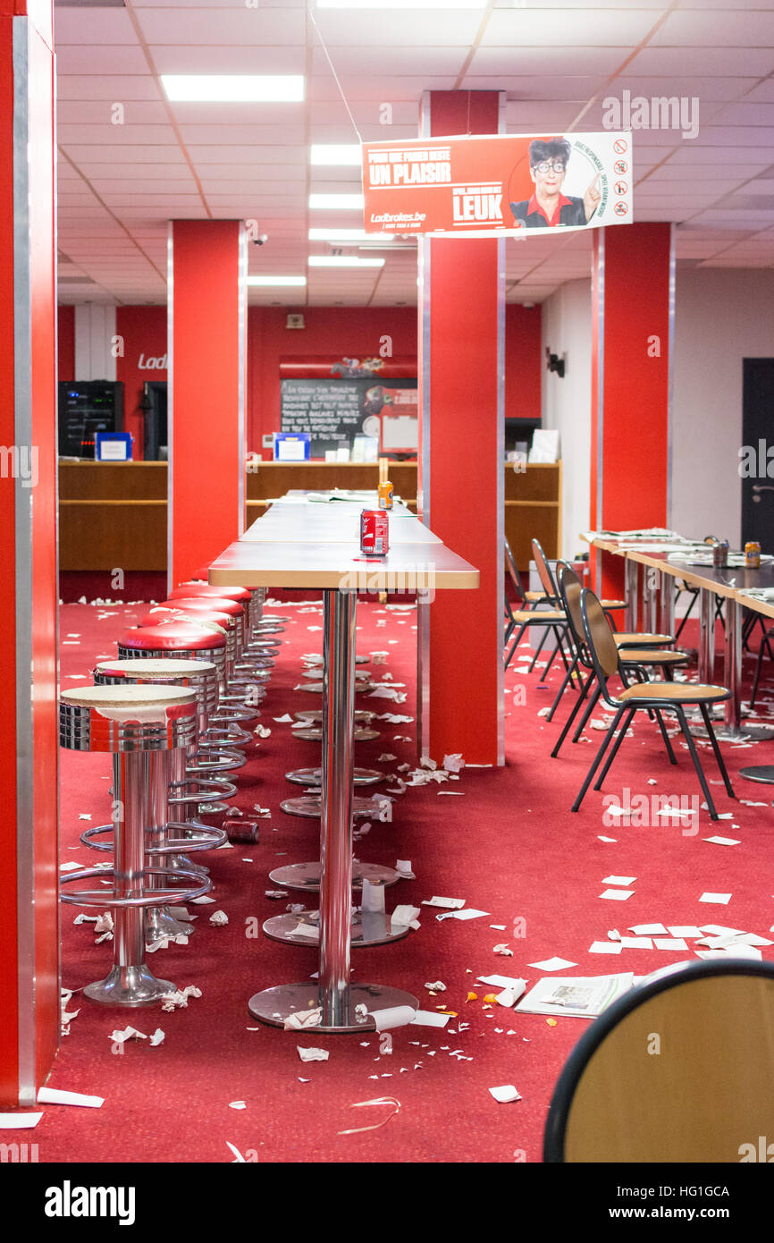 betting shop - inside an empty closed betting shop with torn betting slips on floor Stock Photo