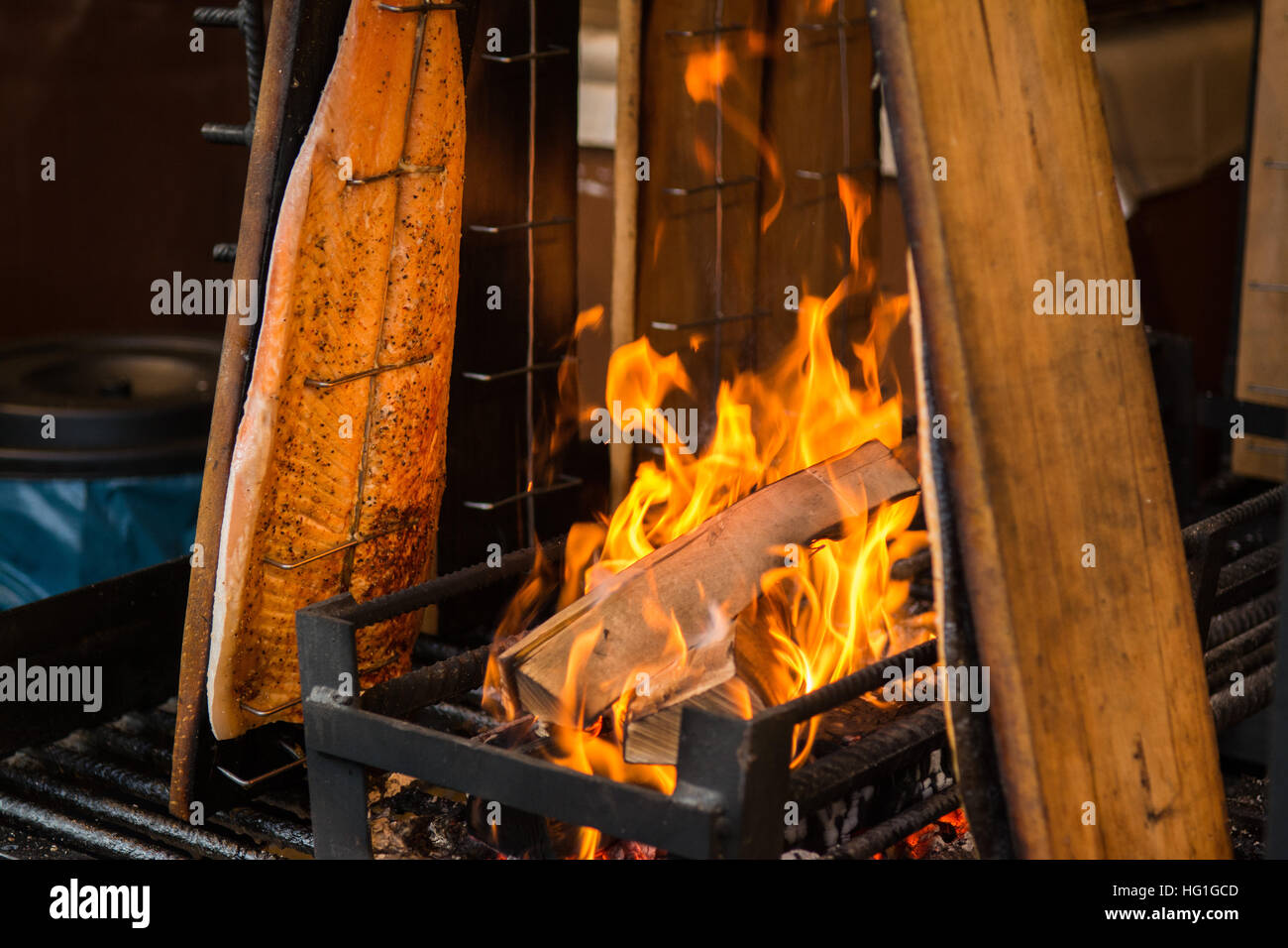 hot smoked salmon smoking by open fire Stock Photo