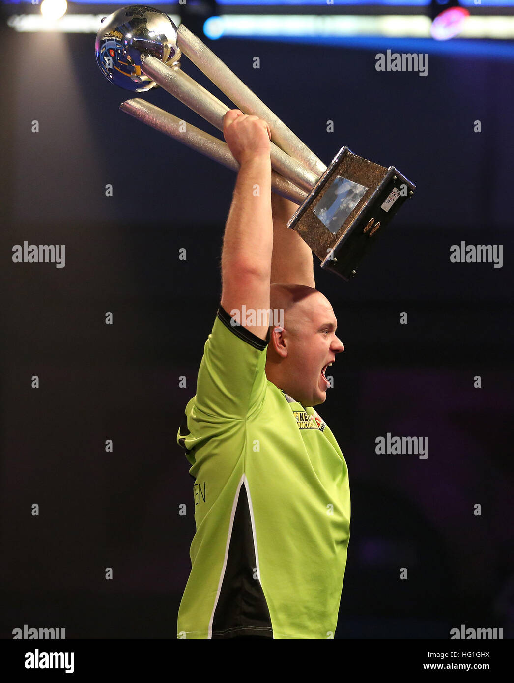 Michael van Gerwen celebrates winning with Sid Waddell trophy during
