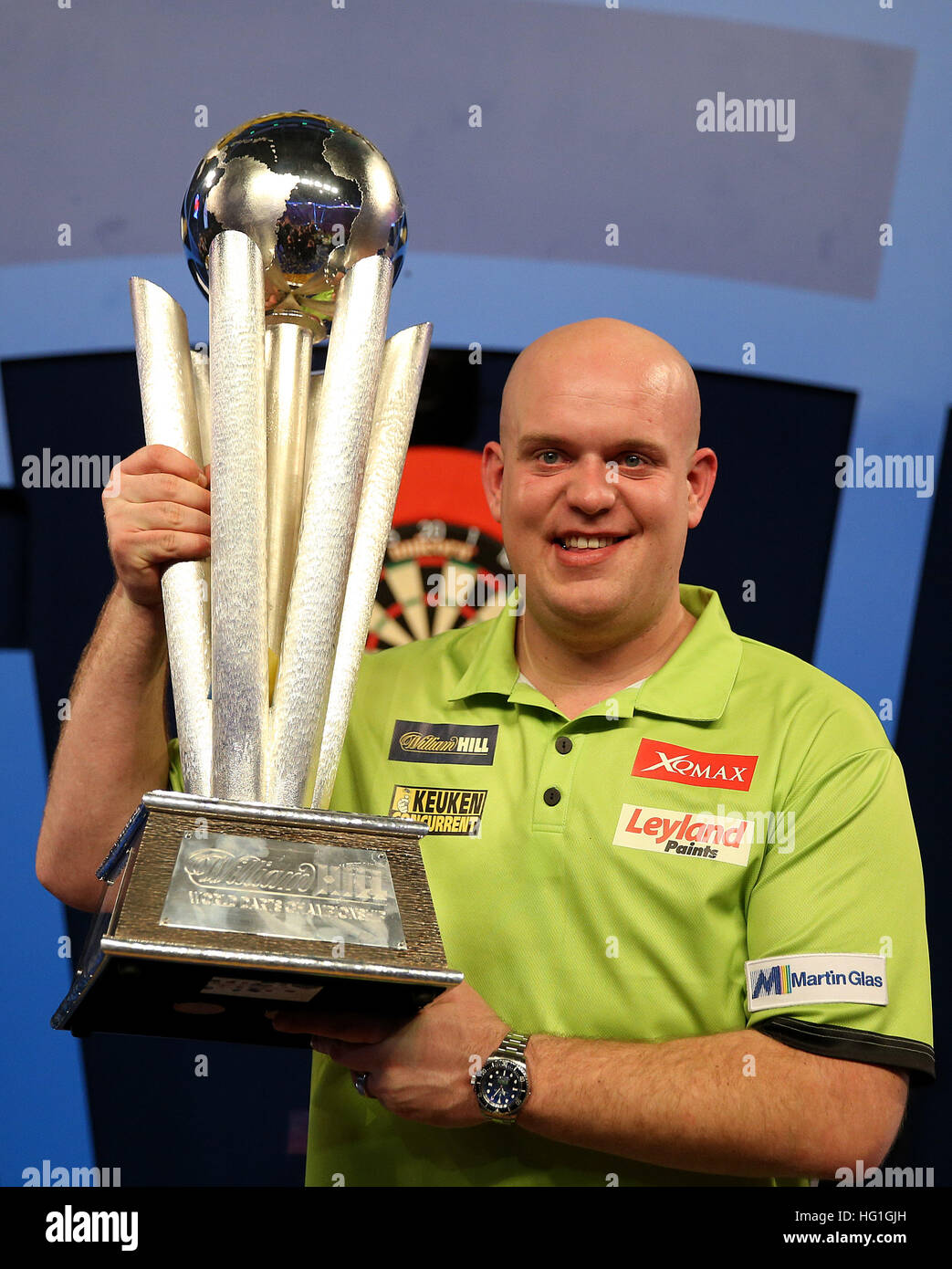 Michael van Gerwen celebrates winning with Sid Waddell trophy during
