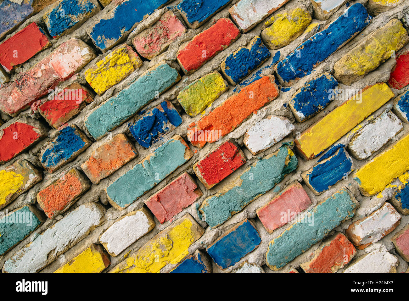 Multicolored painted bricks, exterior wall as background, urban pattern Stock Photo