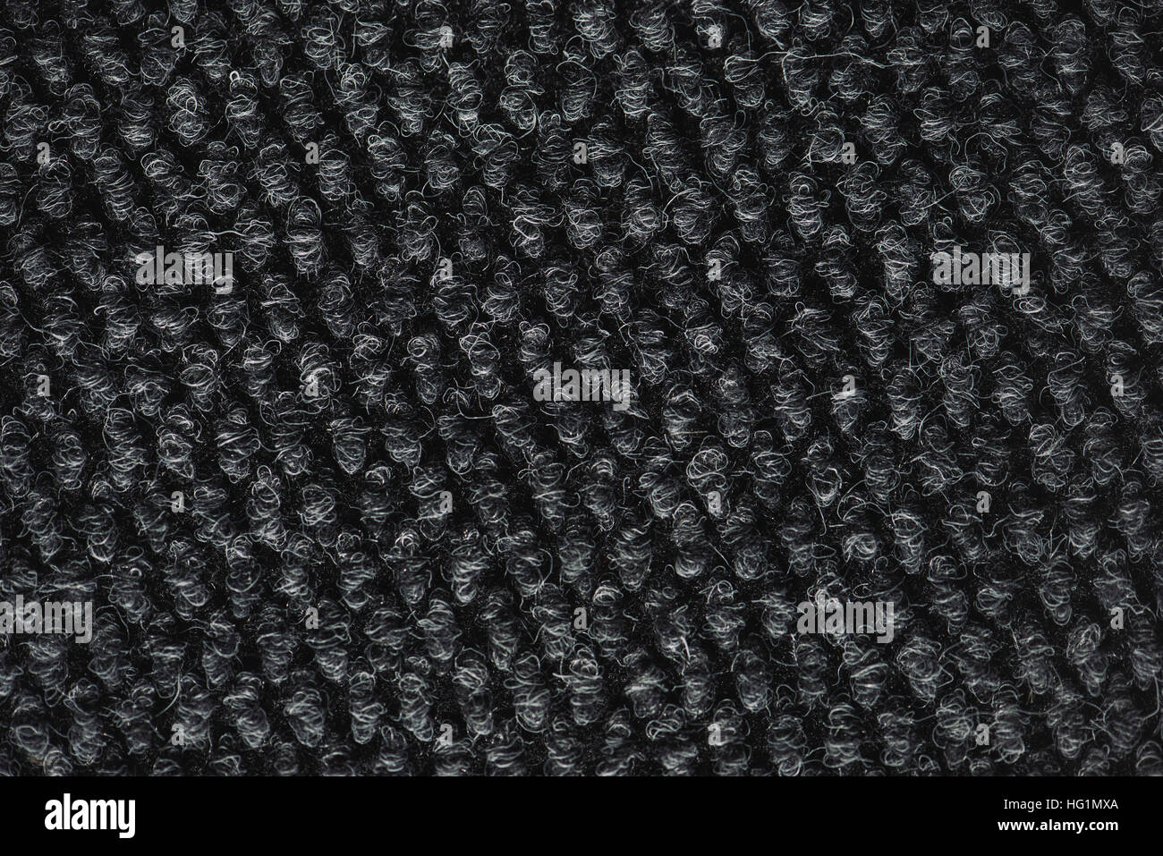 Rough dark carpet texture as background, macro Stock Photo