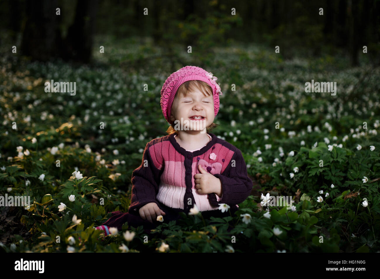 beautiful little girl in forest on flowers field Stock Photo - Alamy
