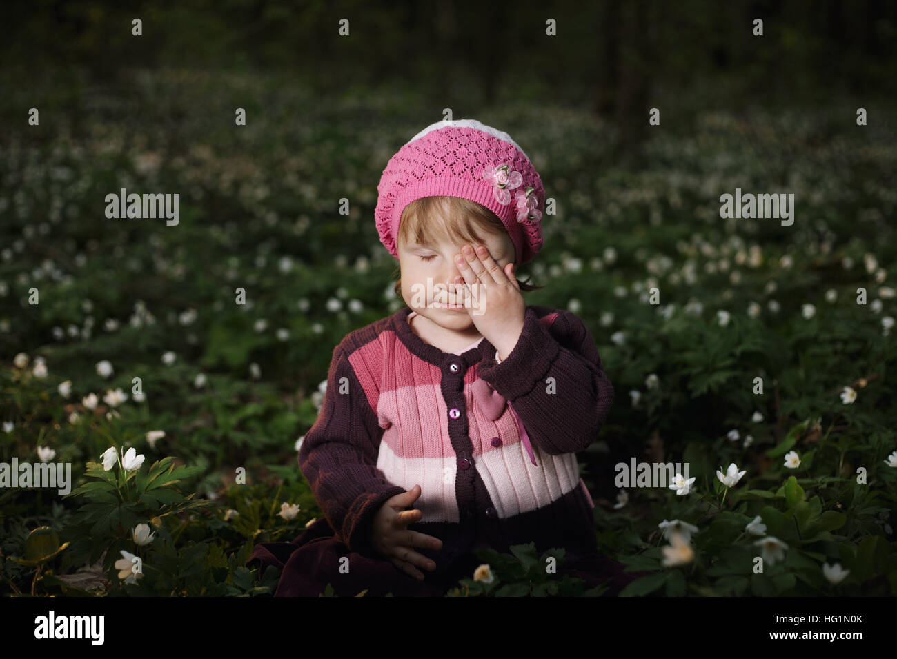 beautiful little girl in forest on flowers field Stock Photo - Alamy