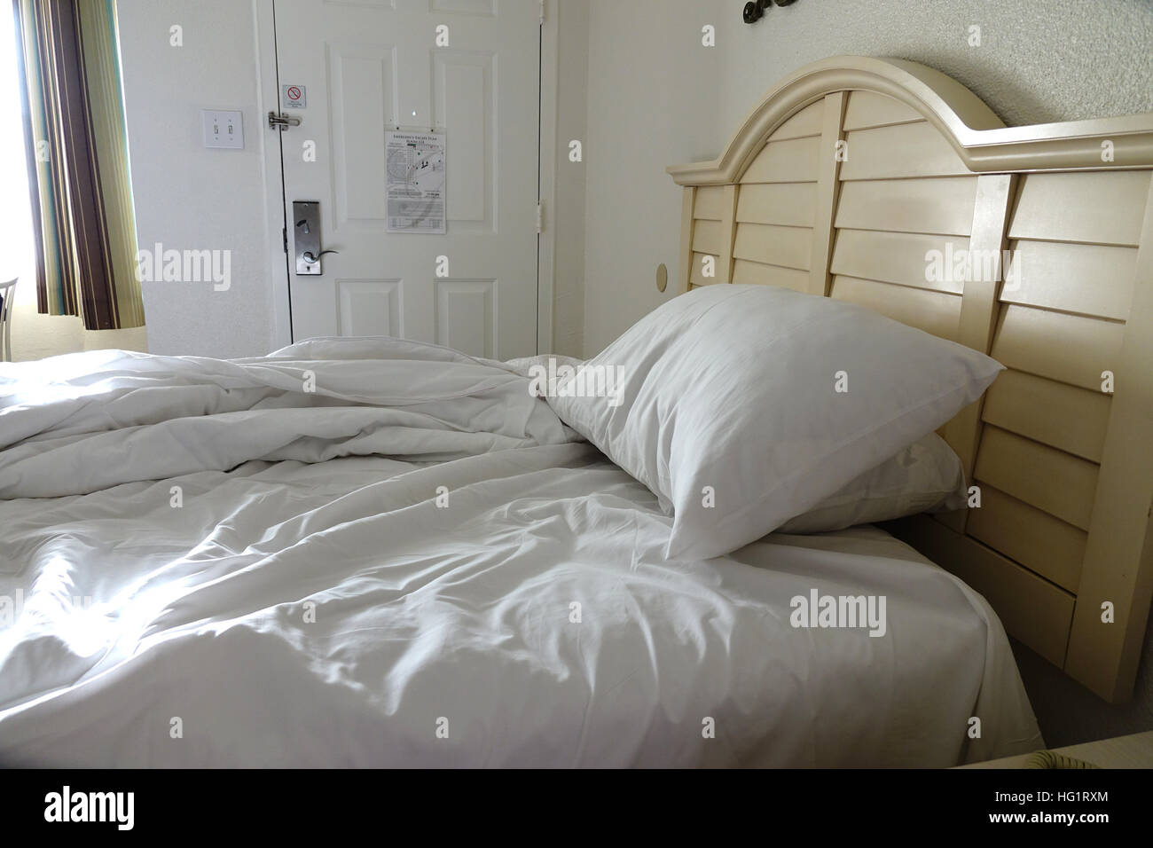 messy unmade hotel bedroom bed USA New Jersey NY motel Stock Photo