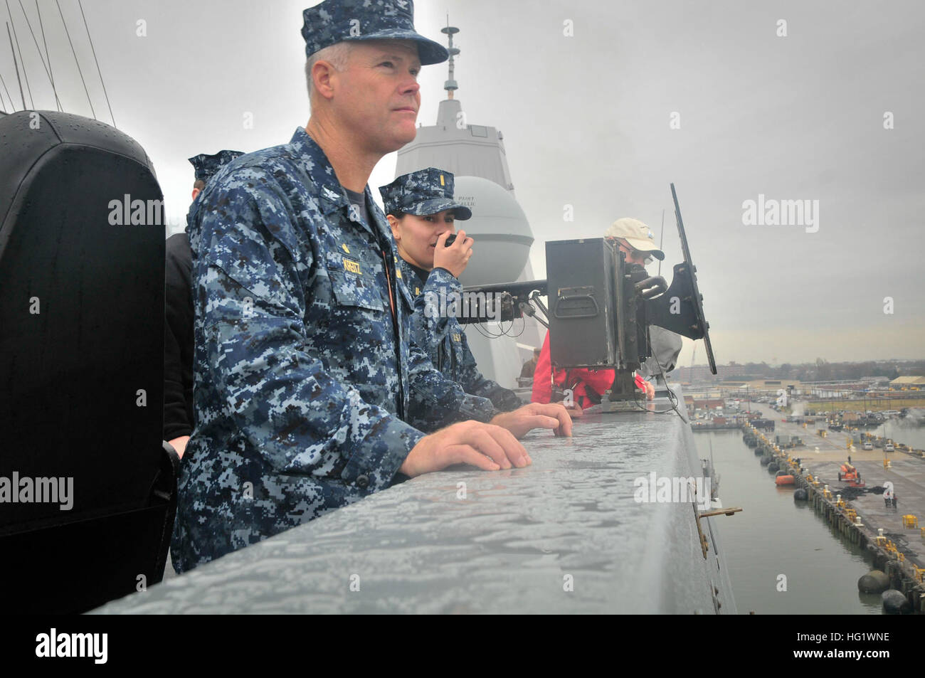 131204-N-YO707-028 NORFOLK (Dec. 4, 2013) Capt. Jon C. Kreitz observes the pier while Ensign Stephanie Flores stands as conning officer aboard the amphibious transport dock ship USS New York (LPD 21) during its transit to Mayport. New York is departing Naval Station Norfolk for a homeport change to Naval Station Mayport. (U.S. Navy photo by Mass Communication Specialist 3rd Class Cyrus Roson/Released) USS New York operations 131204-N-YO707-028 Stock Photo