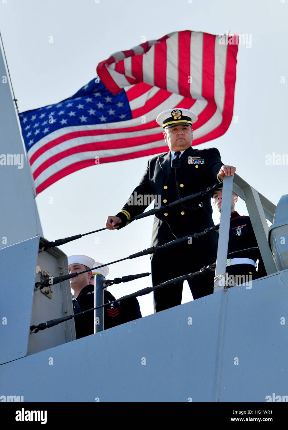 131206-N-MJ645-246 MAYPORT, Fla. (Dec. 6, 2013) An officer aboard the San Antonio-class amphibious transport dock ship USS New York (LPD 21) looks over the side of the ship as it arrives at its new homeport at Naval Station Mayport. The homeport change is part of a larger move of the Iwo Jima Amphibious Ready Group homeport change in support of strategic dispersal and two viable East Coast surface ship homeports as well as the preservation of the ship repair industrial base in those areas. (U.S. Navy photo by Mass Communication Specialist 2nd Class Marcus L. Stanley/Released) USS New York oper Stock Photo