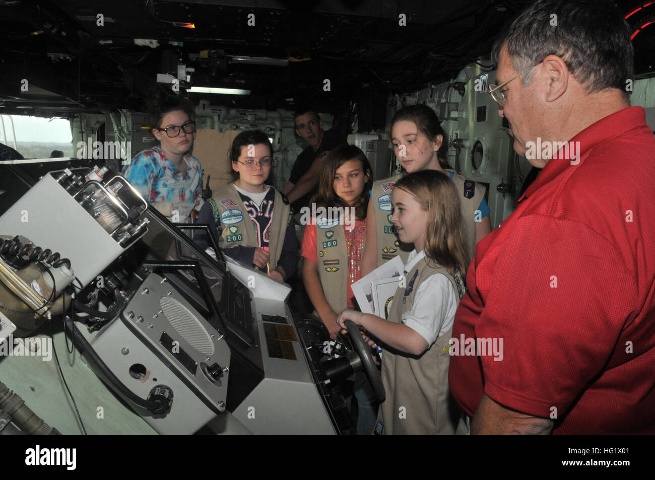 131223-N-GC472-258 MAYPORT, FLA (December 23, 2013) Sailors aboard amphibious transport dock ship USS New York (LPD 21) gives a tour of the ship to Girl Scouts from the Girl Scouts of the USA Gainesville Chapter. New York shifted homeport to Naval Station Mayport, Fla., as part of a larger move of an amphibious ready group homeport change in support of strategic maritime dispersal. (U.S. Navy photo by Mass Communication Specialist 3rd class Angus Beckles/Released) USS New York visit 131223-N-GC472-258 Stock Photo