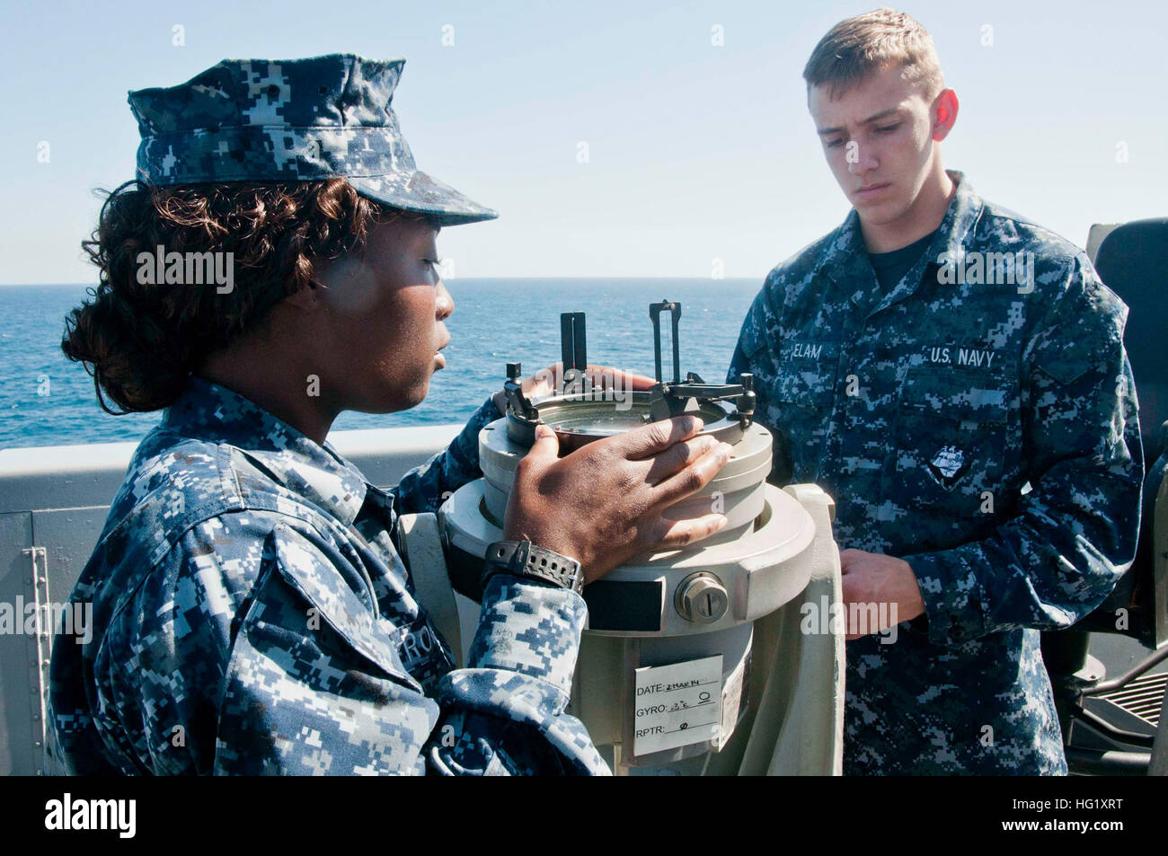140303-N-YO707-036 ATLANTIC OCEAN (March 3, 2014) Quartermaster Seaman Apprentice Natasha M. Rowell, left,  and Quartermaster Seaman Bryan Elam use an azimuth circle to determine the bearing of the sun aboard the amphibious transport dock ship USS New York (LPD 21). New York is underway conducting a routine training exercise. (U.S. Navy photo by: Mass Communication Specialist 2nd Class Cyrus Roson/Released) USS New York operations 140303-N-YO707-036 Stock Photo