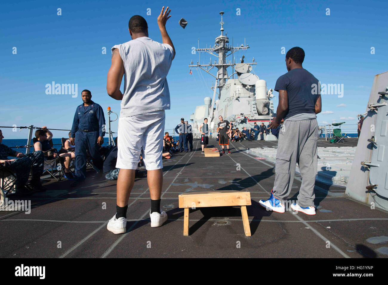 U.S. Sailors play a game of corn hole during a steel beach picnic May 26, 2014, aboard the guided missile destroyer USS Jason Dunham (DDG 109) in the Atlantic Ocean. (U.S. Navy photo by Mass Communication Specialist 3rd Class Derek Paumen/Released) USS Jason Dunham 140526-N-NK134-508 Stock Photo
