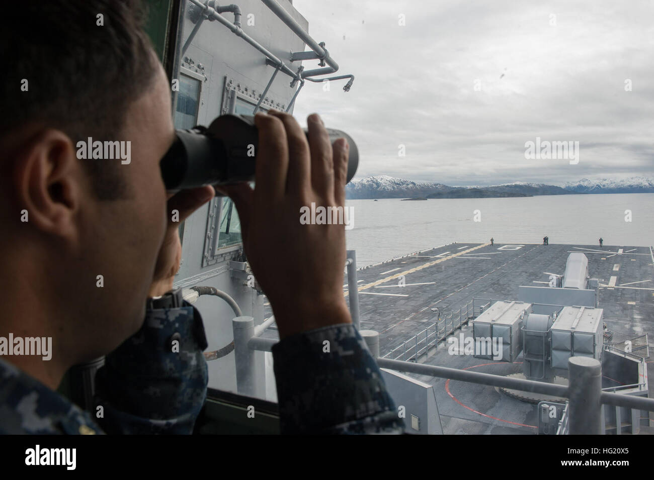 Chief Gunner's Mate Jaime Quinones, assigned to future amphibious assault ship USS America (LHA 6), scans the horizon as the ship transits the Strait of Magellan. America is currently traveling through the U.S. Southern Command and U.S. 4th Fleet area of responsibility on her maiden transit, 'America visits the Americas.' America is the first ship of its class, replacing the Tarawa-class of amphibious assault ships. As the next generation 'big-deck' amphibious assault ship, America is optimized for aviation, capable of supporting current and future aircraft such as the MV-22 Osprey and F-35B J Stock Photo