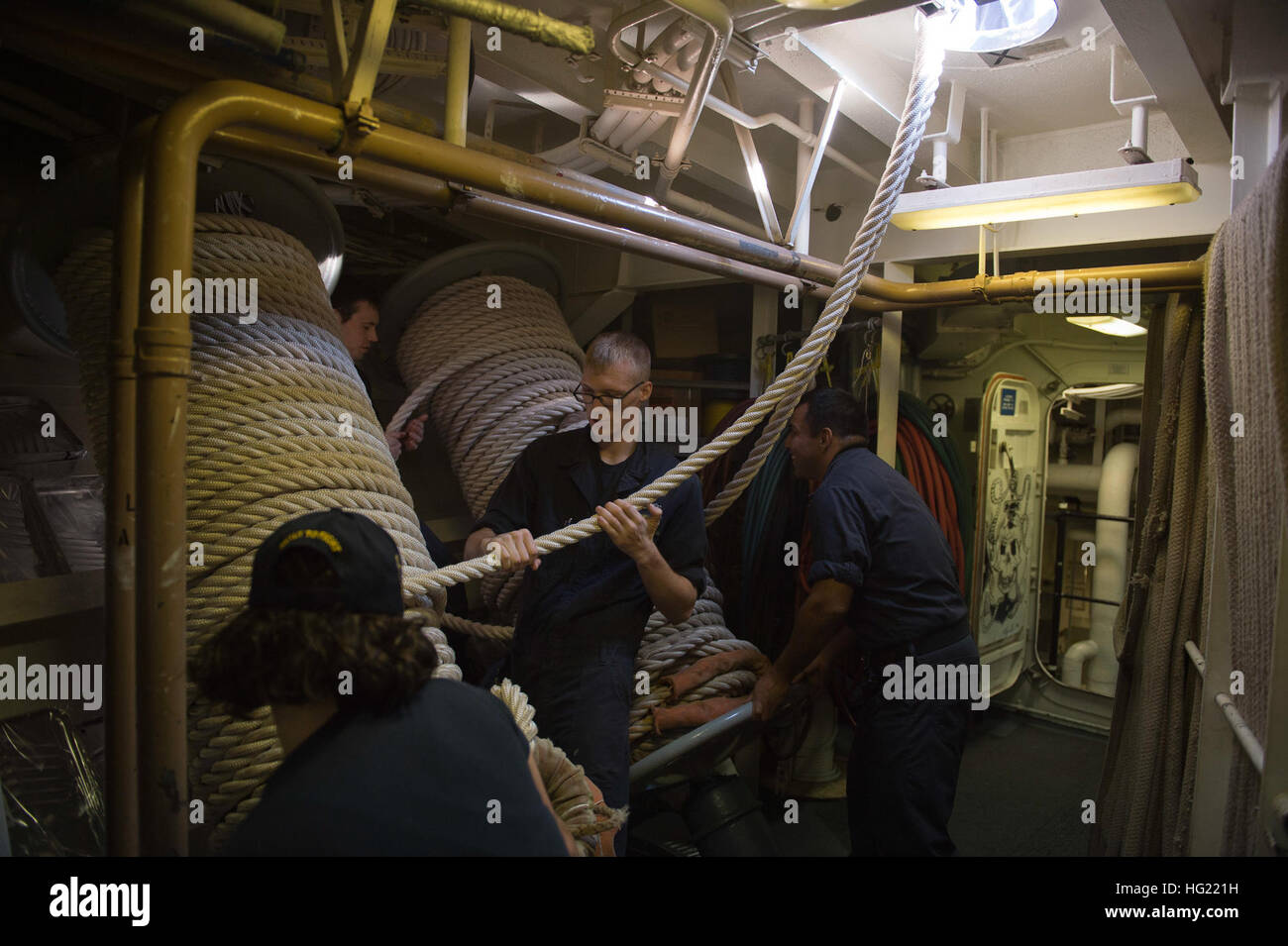 Sailors arrange mooring lines aboard the guidedmissile destroyer USS