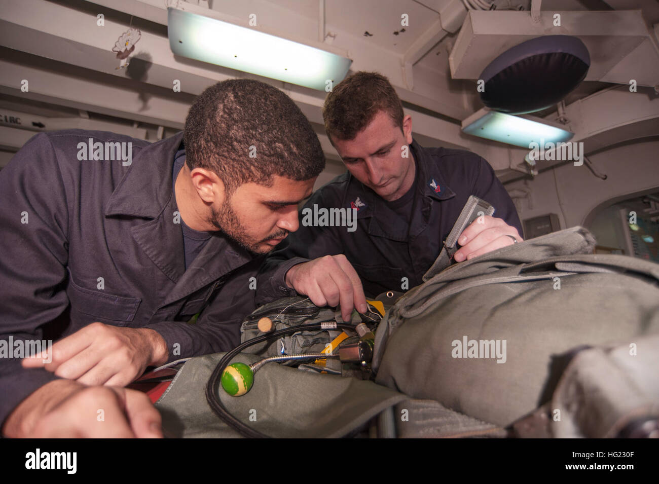 Aircrew Survival Equipmentman 2nd Class Ryan LaFone, right, teaches