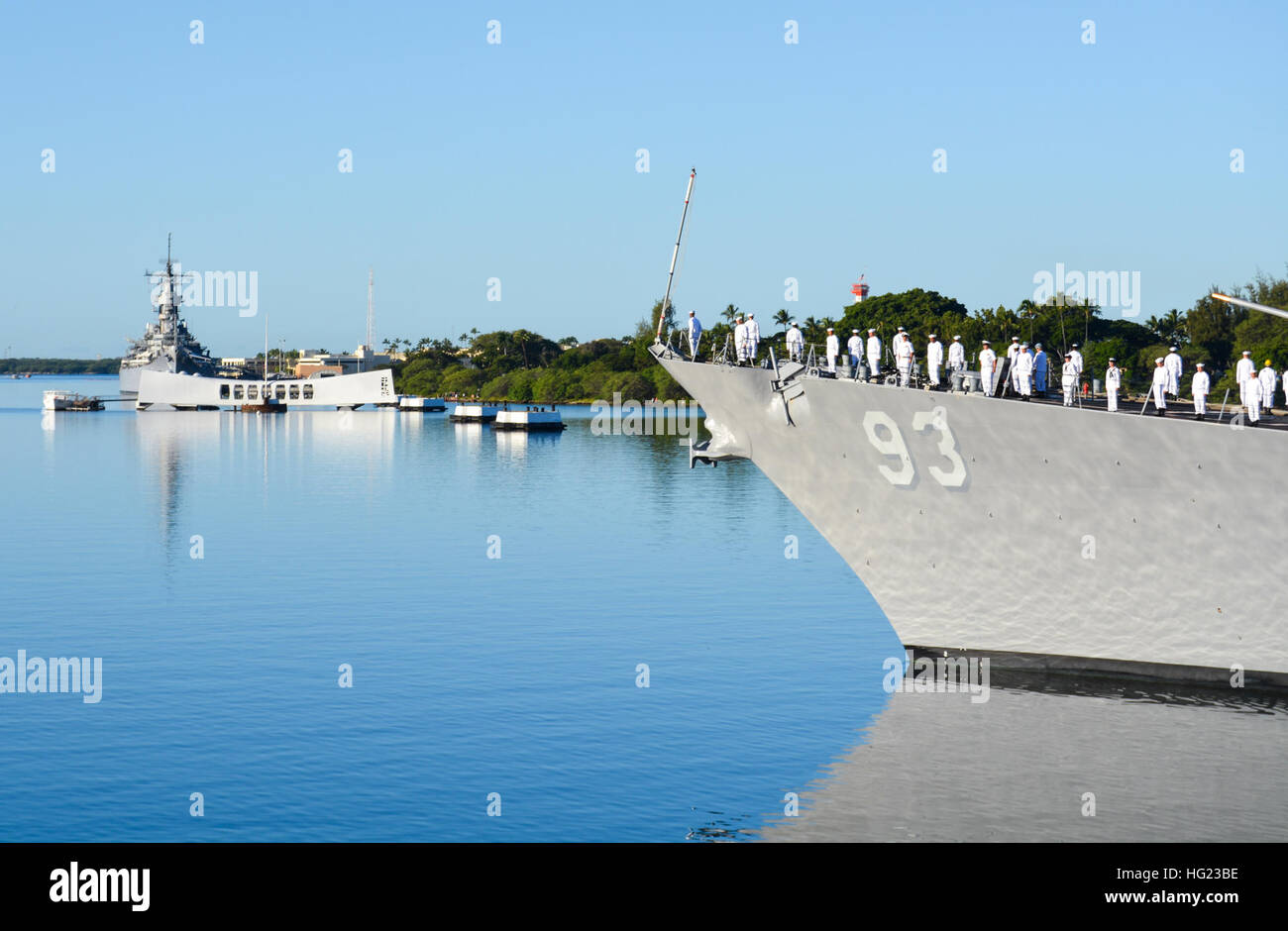 The guided-missile destroyer USS Chung-Hoon (DDG 93) conducts a pass-in-review by the USS Arizona Memorial during the 73rd Anniversary Pearl Harbor Day commemoration ceremony at the Pearl Harbor Visitor Center. More than 2,000 guests, including Pearl Harbor survivors and other veterans, attended the National Park Service and U.S. Navy-hosted joint memorial ceremony at the World War II Valor in the Pacific National Monument. This year's theme focused on 'Preserving the Memory.' (U.S. Navy photo by Mass Communication Specialist 1st Class Katherine Hofman/Released) USS Chung-Hoon operations 14120 Stock Photo
