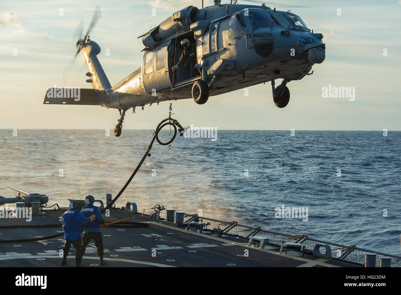 Sailors aboard the guided-missile destroyer USS Cole (DDG 67) stand ...