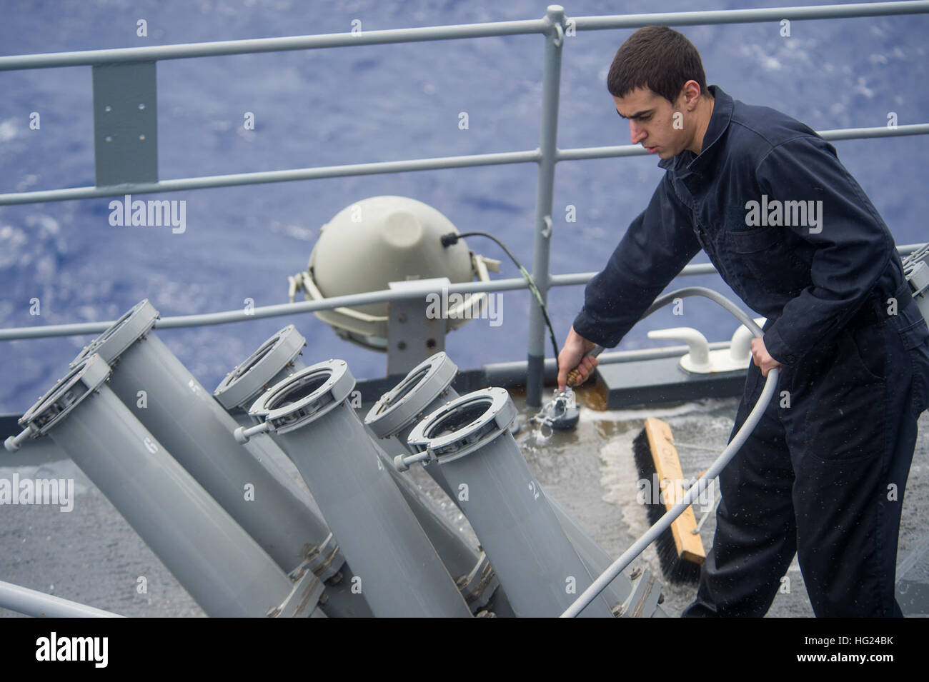 150210-N-CU914-068   PACIFIC OCEAN (Feb. 10, 2015) – Cryptological Technician (Technical) Seaman Apprentice Scott J. Ferer, from Buffalo, N.Y., hoses down a chaff launcher aboard the dock landing ship USS Comstock (LSD 45) during a fresh-water wash-down. Comstock, part of the Makin Island Amphibious Ready Group, and the embarked 11th Marine Expeditionary Unit are returning to homeport San Diego following a seven-month deployment to the Western Pacific and the U.S. Central Command areas of operation. (U.S. Navy photo by Mass Communication Specialist 3rd Class Lenny LaCrosse/Released) USS Comsto Stock Photo