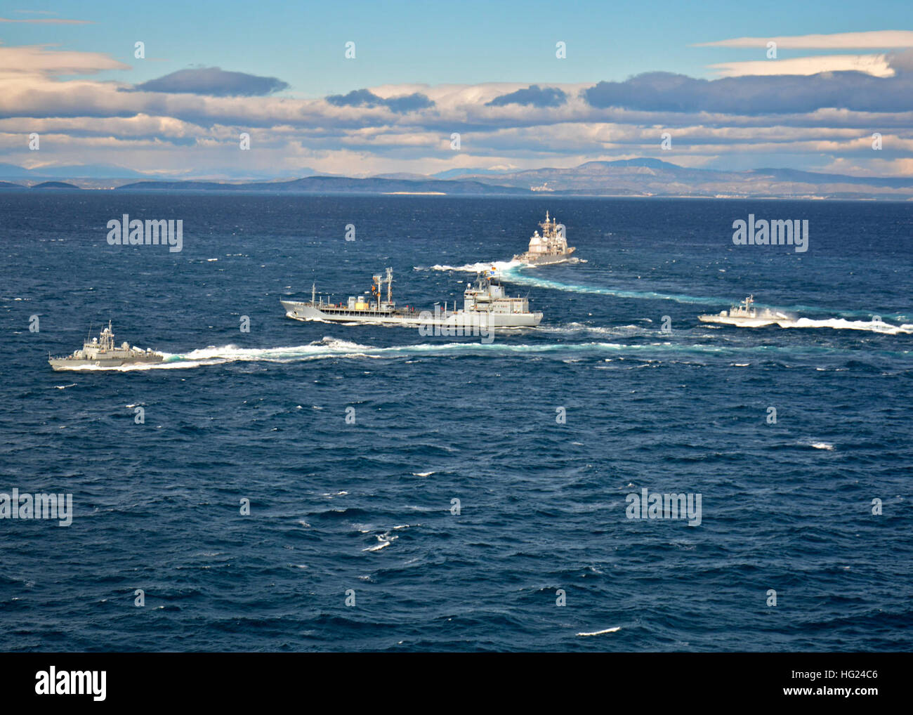 150210-N-IY633-175  ADRIATIC SEA (Feb. 10, 2015) The Standing NATO Maritime Group 2 (SNMG2) ships German navy oiler FGS Spessart (A 1442), center, and flagship guided-missile cruiser USS Vicksburg (CG 69), top, participate in  replenishment-at-sea maneuvers between SNMG2 and Croatian missile boats Dmitar Zvonimir (RTOP-12), left, and Šibenik (RTOP-21), right. SNMG2 ships exercised with the Croatian Navy after a port visit to Split, Croatia. SNMG2 is a multinational integrated force that projects a constant and visible reminder of the Alliance’s solidarity and cohesion afloat. (U.S. Navy photo  Stock Photo
