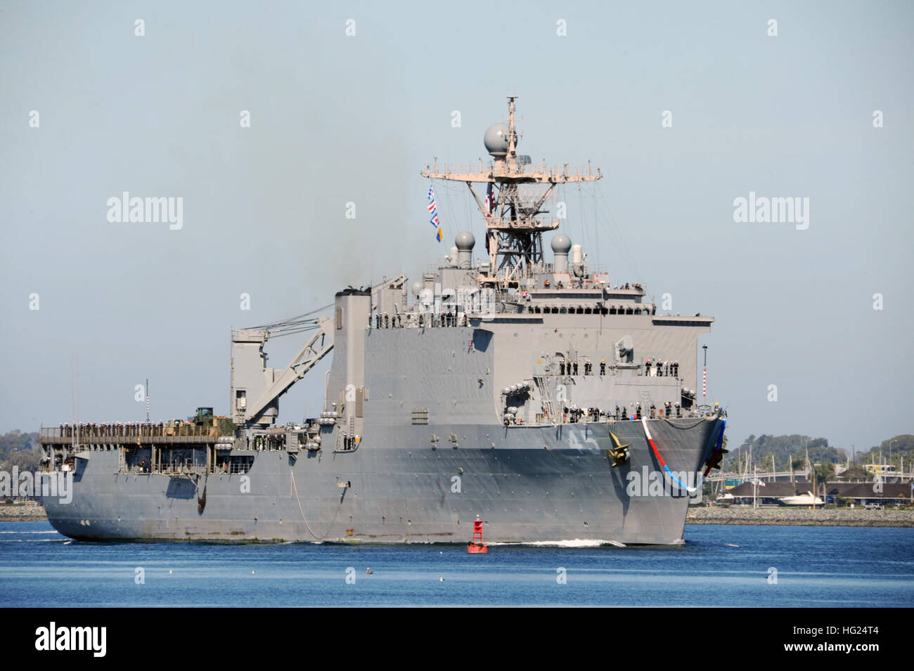 SAN DIEGO (Feb. 25, 2015)- Dock landing ship USS Comstock (LSD 45), returns to homeport Naval Base San Diego following a seven-month deployment to the U.S. 5th and 7th Fleet areas of operations, Feb. 25, as part of the Makin Island Amphibious Ready Group (ARG).  Deployed since July 25, the Makin Island ARG, conducted a relocation of National Oceanographic Atmospheric Administration researchers from Tropical Storm Iselle near Hawaii, conducted air strikes against Islamic State of Iraq and the Levant (ISIL) in Iraq, worked with British and Kuwaiti forces in Exercise Cougar Voyage 14, participate Stock Photo