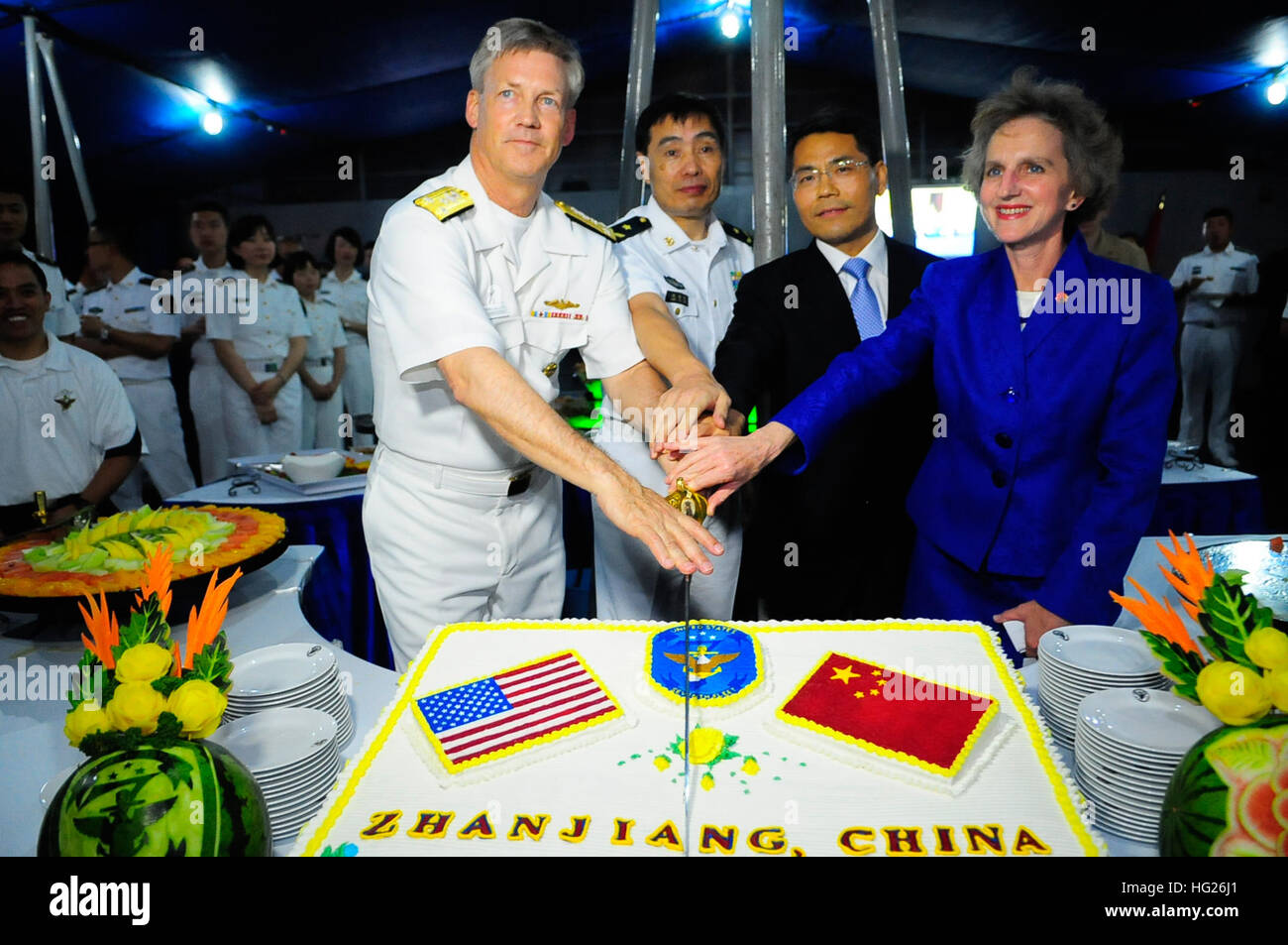 150421-GR655-N-237 ZHANJIANG, People’s Republic of China (April 21, 2015) – From the right, Jennifer Galt, U.S. Consulate General, Guangzhou; Wang Zhongbing, mayor of Zhanjiang; People’s Liberation Army Navy PLA(N) Vice Adm. Shen Jinlong, commander, South Sea Fleet; and U.S. Navy Vice Adm. Robert L. Thomas Jr., commander, U.S. 7th Fleet cut a ceremonial cake during a reception aboard the U.S. 7th Fleet flagship USS Blue Ridge (LCC-19) April 21, 2015. Blue Ridge is conducting a port visit to Zhanjiang to build naval partnerships with China’s South Sea Fleet to ensure peace and prosperity for th Stock Photo