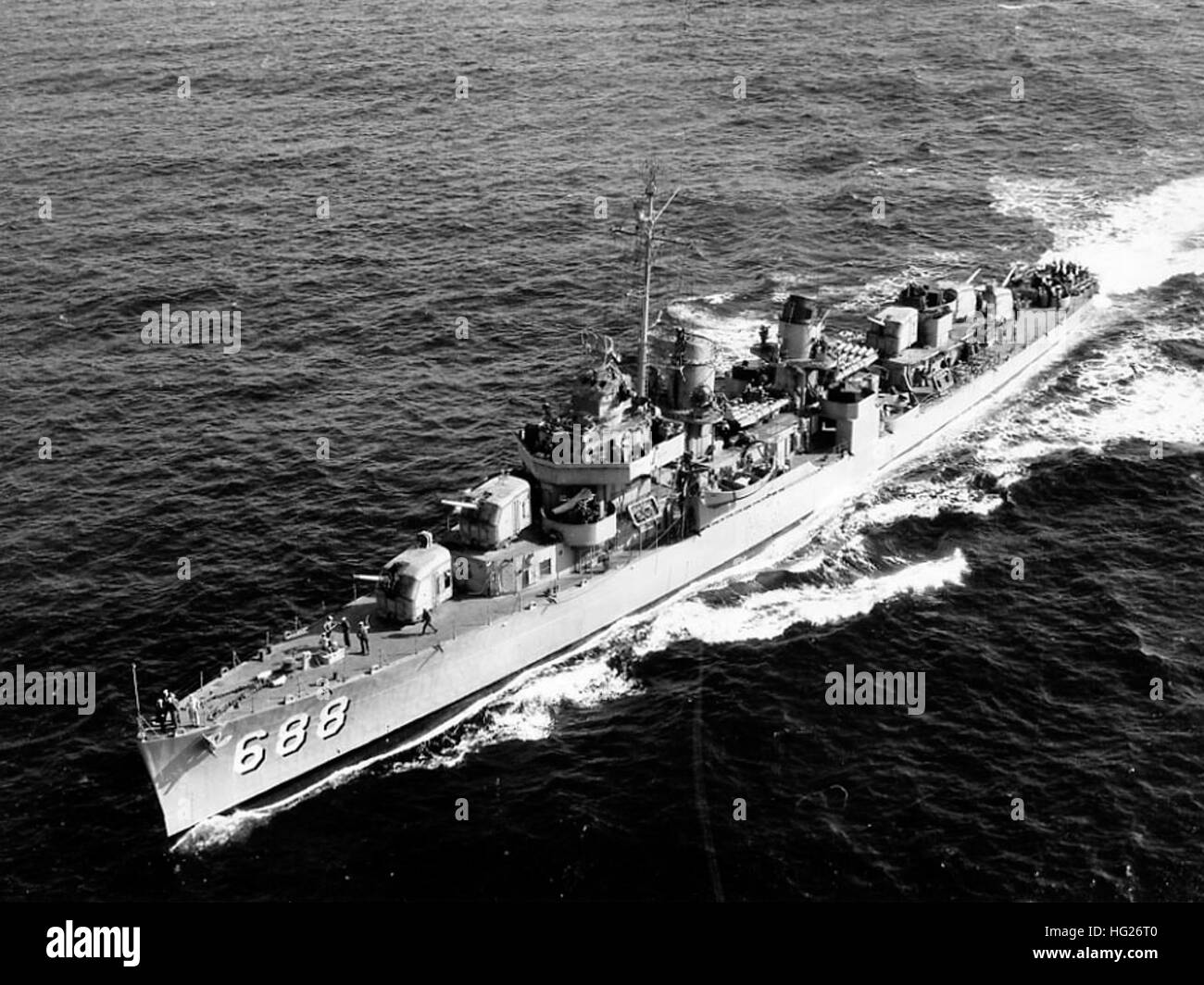 USS Remey (DD-688) underway at sea, probably in late 1951 or early 1952, soon after she was recommissioned during the Korean War build up. Note that she still has a pole mast, World War II era radars, all ten 21-inch torpedo tubes, twin 40mm gun mounts just forward of her bridge and 20mm guns on her fantail. This photograph was received by the Naval Photographic Center in December 1959, but was actually taken several years earlier.  Official U.S. Navy Photograph, from the collections of the Naval History and Heritage Command. USS Remey (DD-688) at sea c1951 Stock Photo