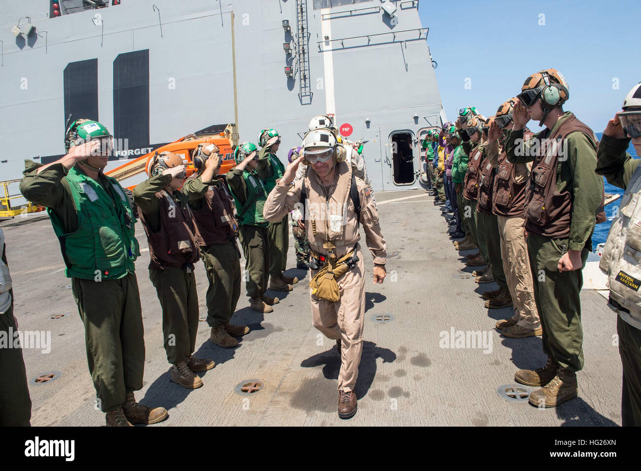 150501-N-XG464-224 GULF OF ADEN (May 1, 2015) - Capt. Christopher Brunett, from Buffalo, N.Y., and former commanding officer of the amphibious transport dock ship USS New York (LPD 21), salutes rainbow side boys in preparation for departure. New York is a part of the Iwo Jima Amphibious Ready Group (ARG) and, with the embarked 24th Marine Expeditionary Unit (MEU), is deployed in support of maritime security operations and theater security cooperation efforts in the U.S. 5th Fleet area of operations. (U.S. Navy photo by Mass Communication Specialist 3rd Class Jonathan B. Trejo/Released) USS New Stock Photo