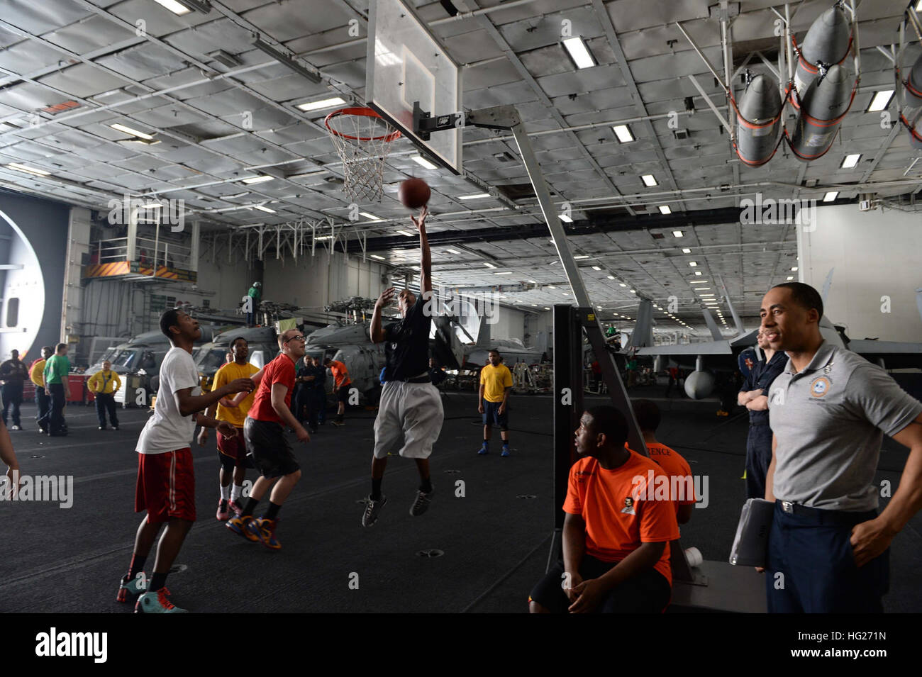150503-N-ZF498-586 U.S. 5TH FLEET AREA OF OPERATIONS (May 3, 2015) – Sailors participate in a basketball tournament in the hangar bay of the aircraft carrier USS Theodore Roosevelt (CVN 71). Theodore Roosevelt is deployed in the U.S. 5th Fleet area of operations supporting Operation Inherent Resolve, strike operations in Iraq and Syria as directed, maritime security operations and theater security cooperation efforts in the region. (U.S. Navy photo by Mass Communications Specialist 3rd Class Anthony N. Hilkowski) USS Theodore Roosevelt operations 150503-N-ZF498-586 Stock Photo