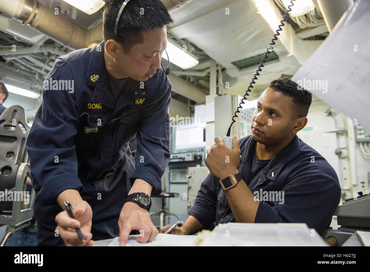 150525-N-VC236-002  GULF OF OMAN (May 25, 2015) - Chief Gas Turbine System Technician (Mechanical) Seung Song, from Jacksonville, Fla., gives instructions to Lt. j.g. Ramon Cortes, from Columbus, Ohio, during engineering training team drills aboard the guided-missile destroyer USS Farragut (DDG 99). Farragut is deployed to the U.S. 5th Fleet area of operations as part of Theodore Roosevelt Carrier Strike Group supporting Operation Inherent Resolve, strike operations in Iraq and Syria as directed, maritime security operations and theater security cooperation efforts in the region. (U.S. Navy ph Stock Photo