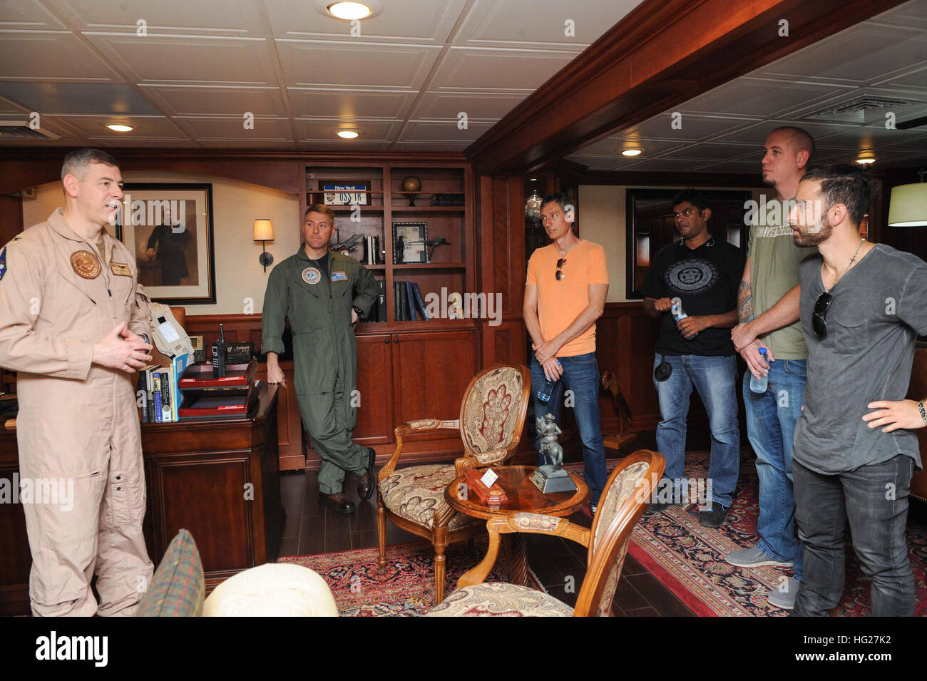 150525-N-FI568-254 U.S. 5TH FLEET AREA OF OPERATIONS (May 25, 2015)- Members of the band for American Idol winner David Cook speak with Capt. Daniel Grieco, commanding officer of the aircraft carrier USS Theodore Roosevelt (CVN 71), before a concert and meet-and-greet onboard. Theodore Roosevelt is deployed in the U.S. 5th Fleet area of operations supporting Operation Inherent Resolve, strike operations in Iraq and Syria as directed, maritime security operations and theater security cooperation efforts in the region. (U.S. Navy photo by Mass Communication Specialist 3rd Class Taylor L. Jackson Stock Photo