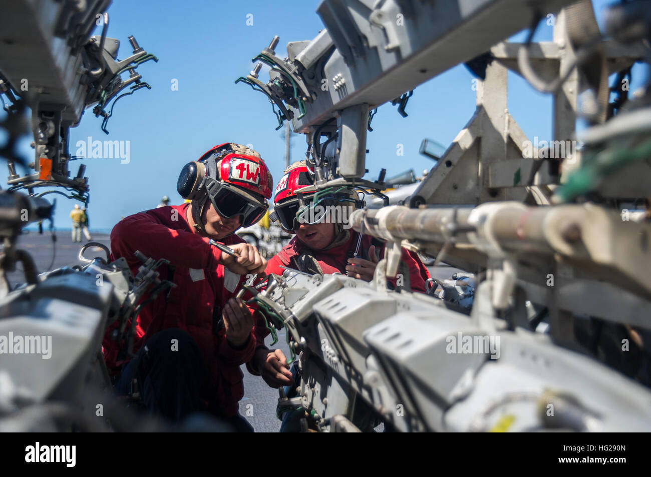 150715-N-EH855-115 TIMOR SEA (July 15, 2015) Aviation Ordnanceman Airman Tyler Lazor, from Defanice, Penn., center-left, and Aviation Ordnanceman 2nd Class Donald Collins, from Tucson, Ariz., prepare bomb racks for loading on the flight deck of the Nimitz-class aircraft carrier USS George Washington (CVN 73) as part of Talisman Sabre 2015. Talisman Sabre is a biennial exercise that provides an invaluable opportunity for nearly 30,000 U.S. and Australian Defence Force personnel to conduct operations in a combined, joint and interagency environment that will increase both countries' ability to p Stock Photo