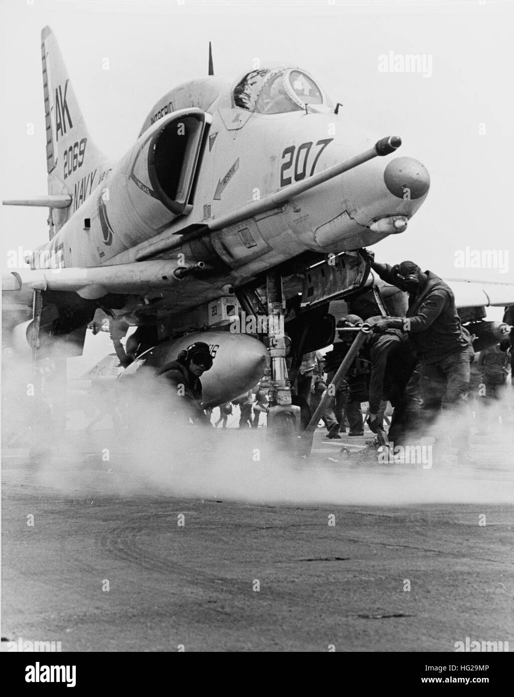Photo #: USN 1135374 Douglas A-4E Skyhawk attack plane Is brought to the launching position on a steam catapult aboard USS Intrepid (CVS-11), during flight operations in the Gulf of Tonkin, September 1968. Note nosewheel steering bar in use. Official U.S. Navy Photograph. USS Intrepid (CV-11) - Sep 68 Stock Photo