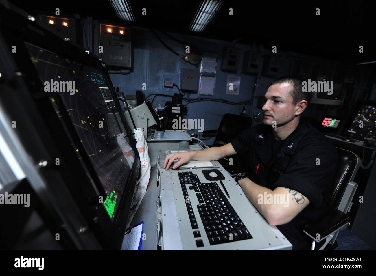 150921-N-PG340-028  ARABIAN GULF (Sept. 21, 2015) – Air Traffic Controller 2nd Class Derrick Hulme, from Sanford, Florida, monitors departing aircraft and ensures tanker assets are available for return from the carrier air traffic control center aboard the aircraft carrier USS Theodore Roosevelt (CVN 71). Theodore Roosevelt is deployed in the U.S. 5th Fleet area of operations supporting Operation Inherent Resolve, strike operations in Iraq and Syria as directed, maritime security operations and theater security cooperation efforts in the region. (U.S. Navy photo by Mass Communication Specialis Stock Photo
