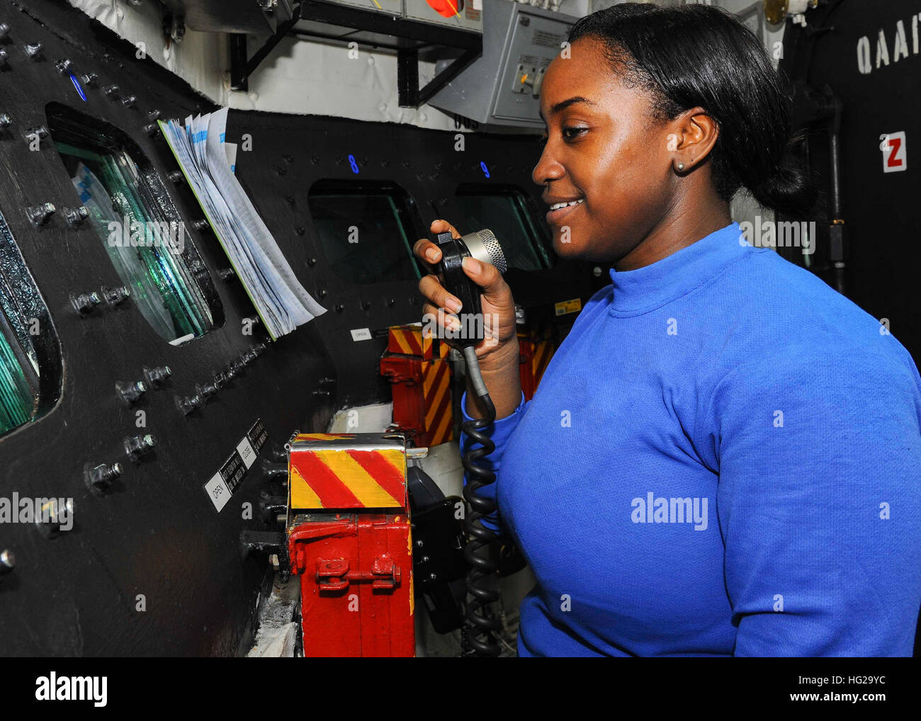 150929-N-CQ428-043  ARABIAN GULF (Sept. 29, 2015) Aviation Boatswain's Mate (Handling) Airman Naquesha Woodberry stands watch over the hangar bay in conflagration station 2 aboard the aircraft carrier USS Theodore Roosevelt (CVN 71). Theodore Roosevelt is deployed in the U.S. 5th Fleet area of operations supporting Operation Inherent Resolve, strike operations in Iraq and Syria as directed, maritime security operations and theater security cooperation efforts in the region. (U.S. Navy photo by Mass Communication Specialist 3rd Class Jennifer Case/Released) USS Theodore Roosevelt operations 150 Stock Photo