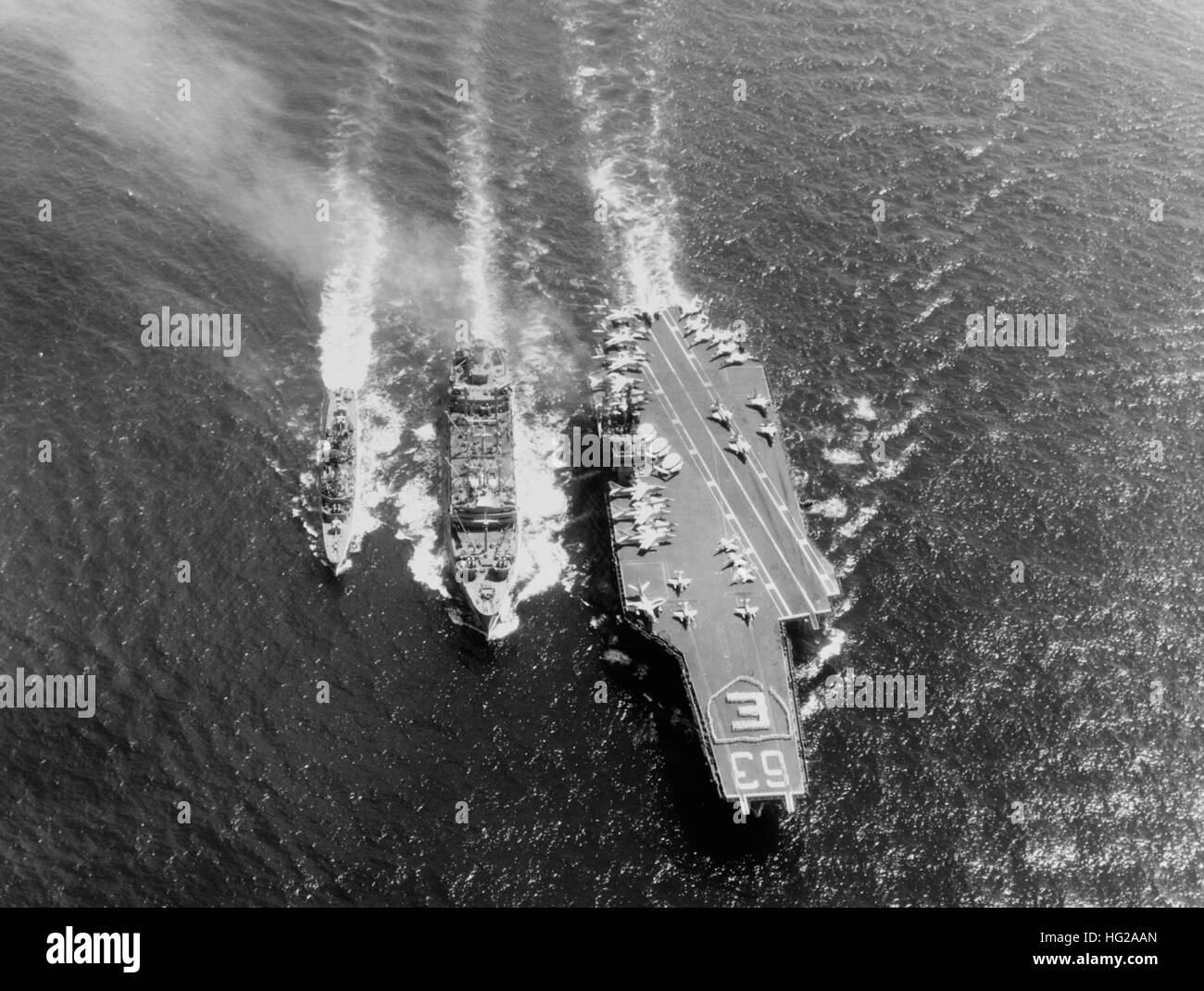 USS Kitty Hawk (CVA-63) and USS Turner Joy (DD-951) refueling from USS Kawishiwi (AO-146) on 23 April 1964 Stock Photo